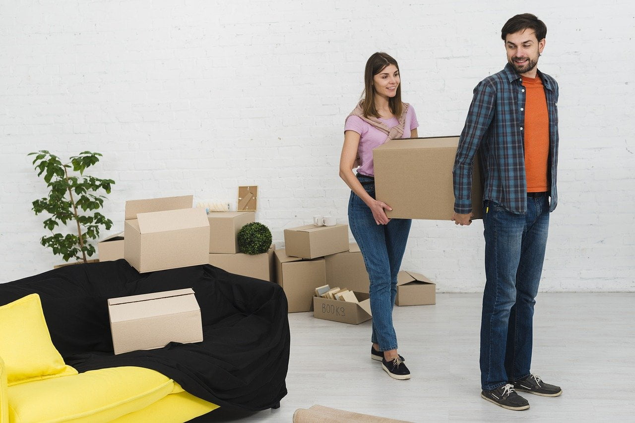 A couple moving boxes
